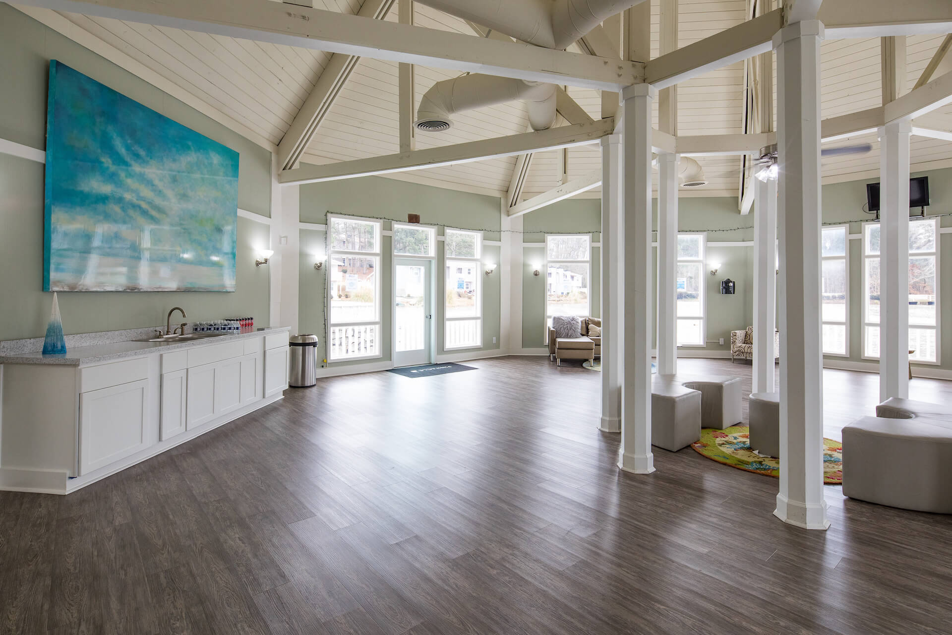 Large community clubhouse with seating overlooking pond