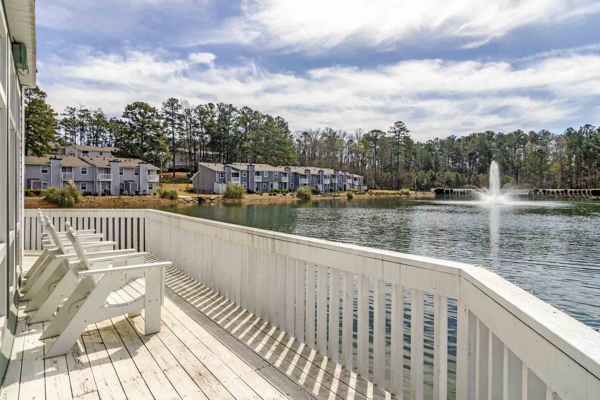 Looking over a lake from a deck with white rails