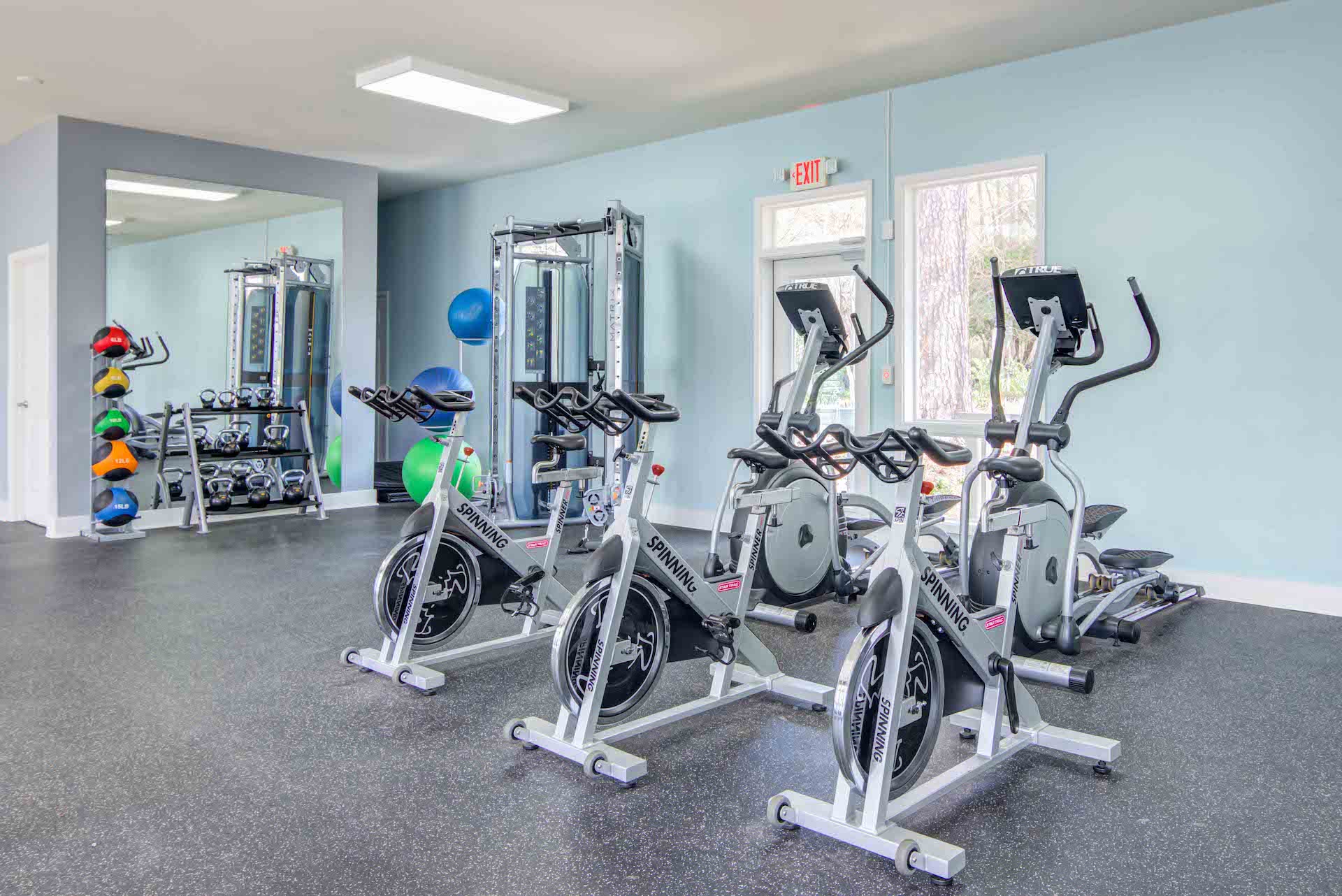 Fitness room showing multiple cycles and workout machines