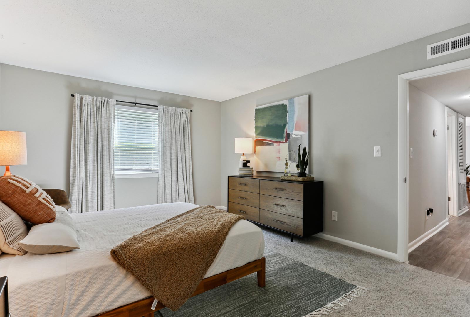 Bedroom with queen size bed and dresser