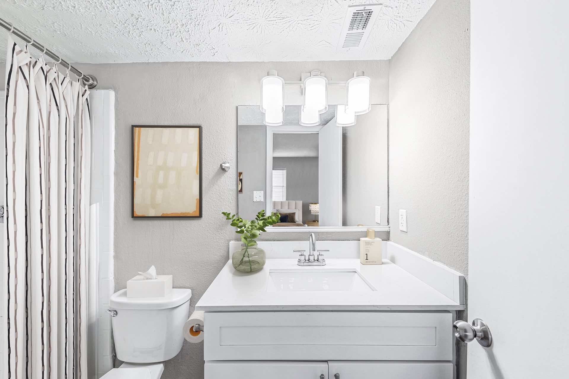 quartz counter in bathroom with ample lighting