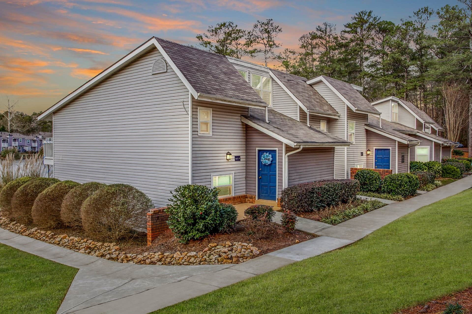 exterior view of apartment building with landscaping