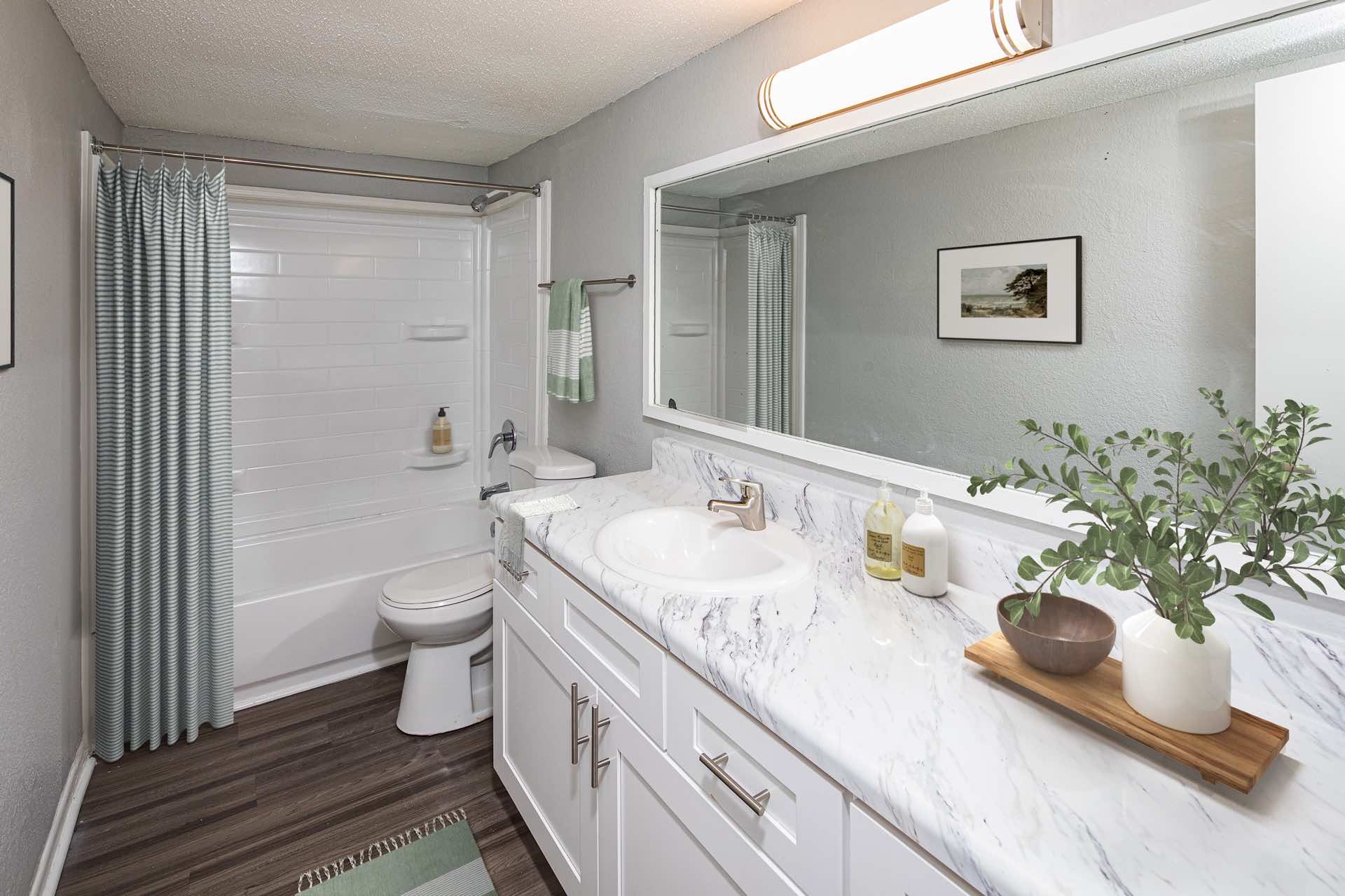 bathroom with wood-style flooring and ample lighting