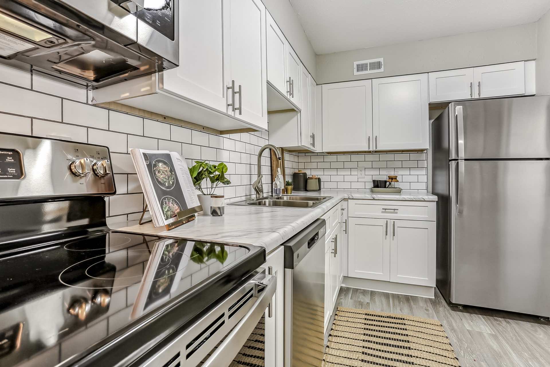 kitchen with stainless steel appliances and white shaker cabinets