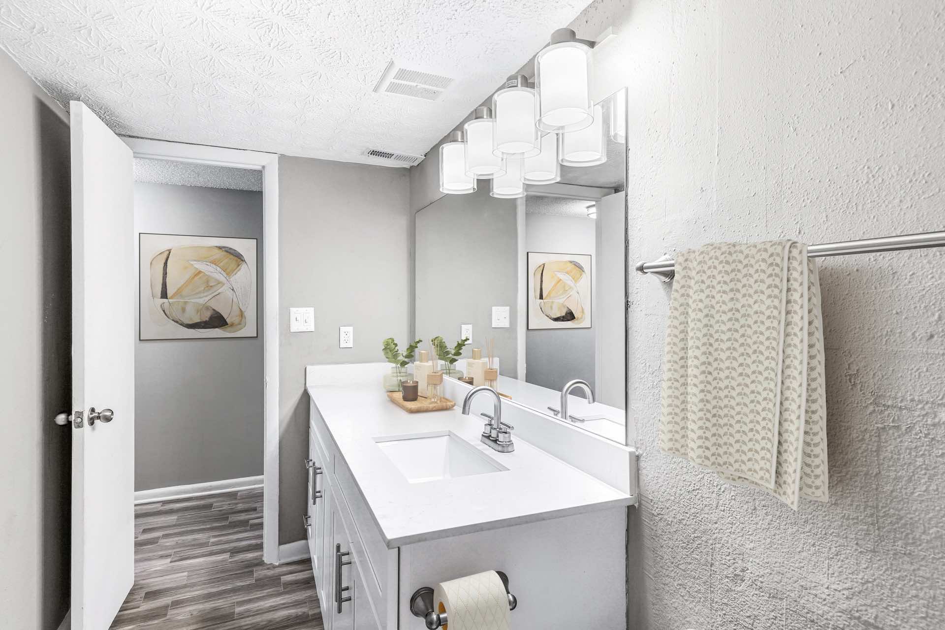 bathroom with wood-style flooring and modern lighting