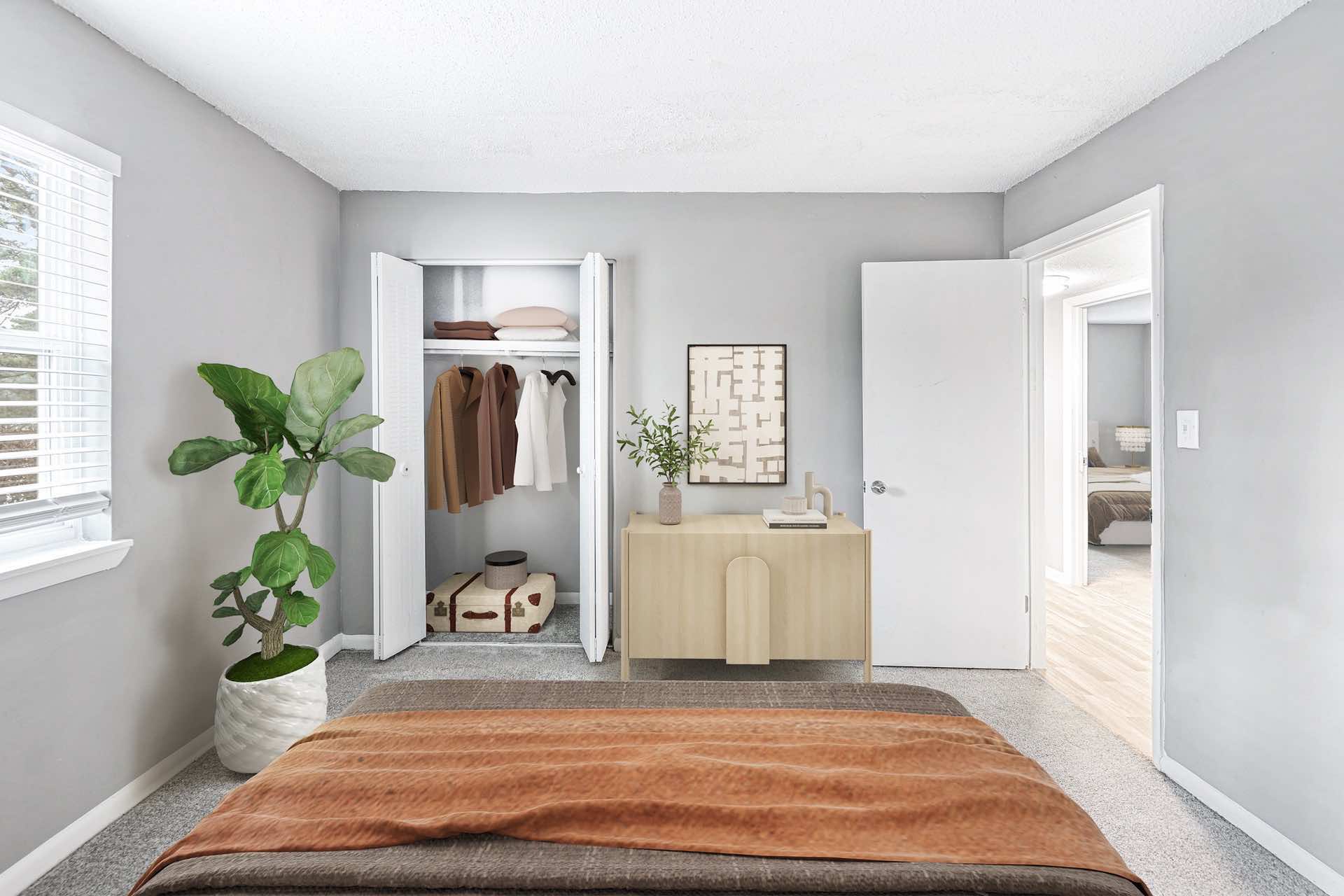 bedroom with natural lighting, plush carpeting, and reach-in closet