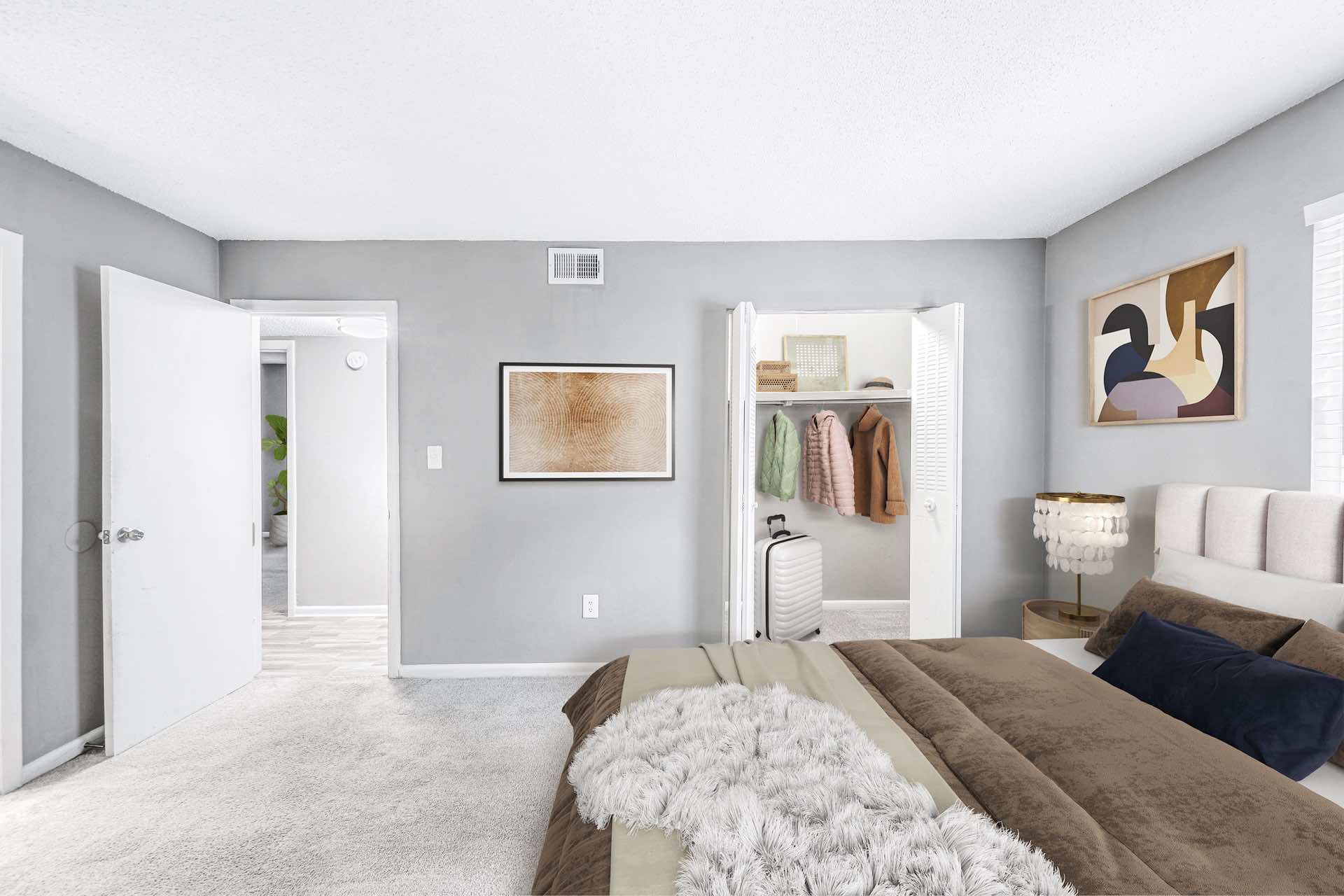 bedroom with natural lighting, plush carpeting, and walk-in closet