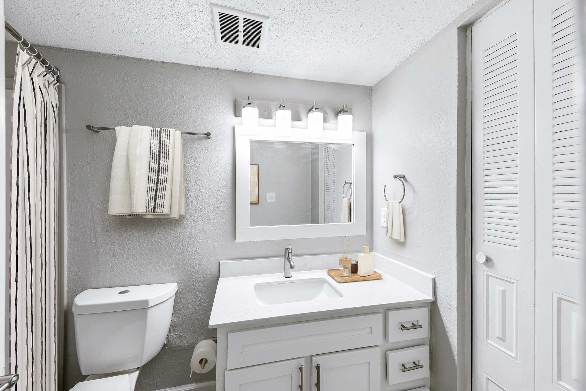 bathroom with modern brushed nickel lighting