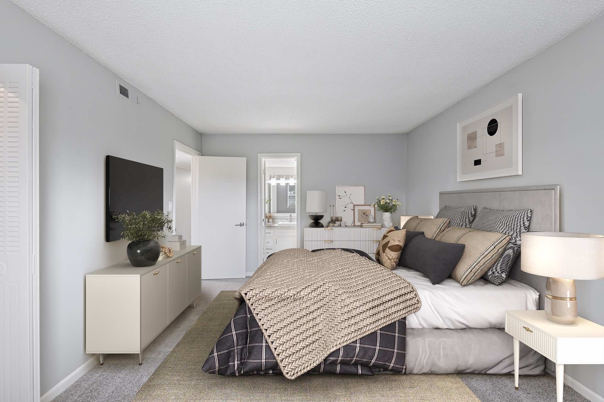 bedroom with natural lighting and plush carpeting leading to bathroom