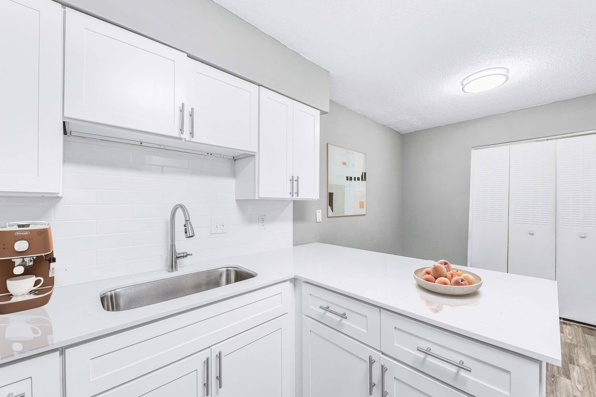 kitchen with white shaker cabinets and white quartz countertops